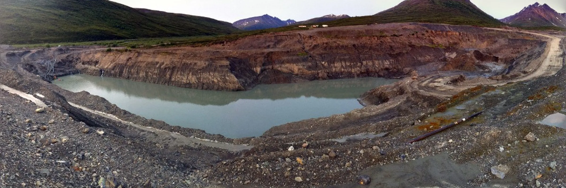 Wide panorama of an Alaska open-pit gold mine